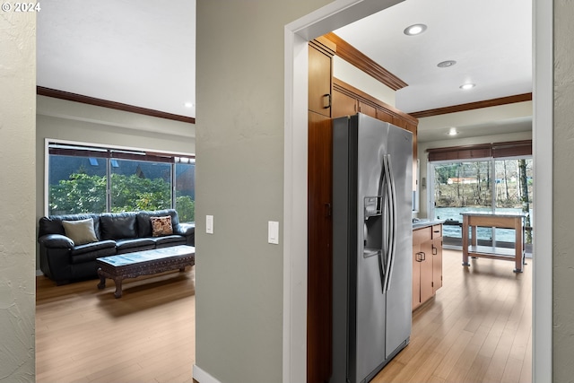 corridor featuring ornamental molding and light hardwood / wood-style floors