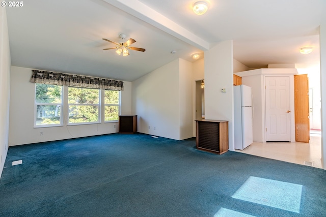 unfurnished living room with carpet, ceiling fan, and lofted ceiling with beams