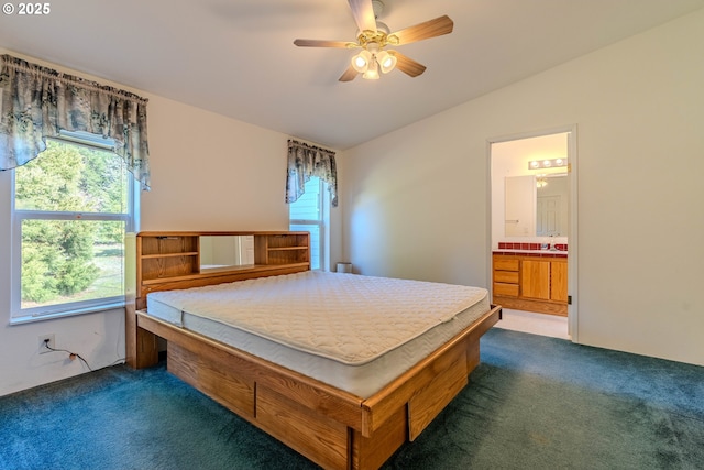 carpeted bedroom featuring connected bathroom, vaulted ceiling, a sink, and a ceiling fan