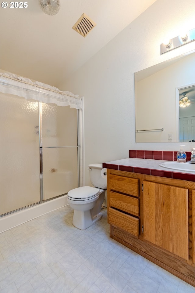 full bathroom with visible vents, lofted ceiling, toilet, a shower with shower door, and vanity