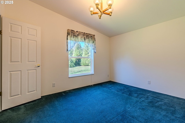 spare room with vaulted ceiling, dark colored carpet, and an inviting chandelier