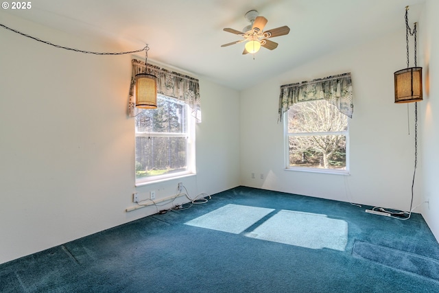 carpeted spare room with lofted ceiling and ceiling fan