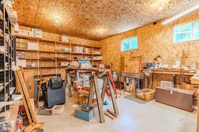 interior space with unfinished concrete flooring and a workshop area