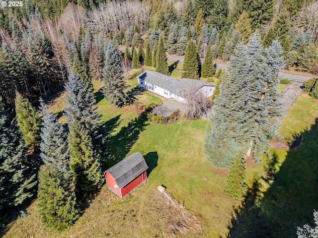 birds eye view of property with a wooded view