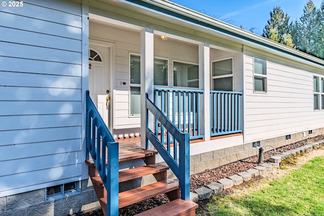 doorway to property featuring a porch and crawl space