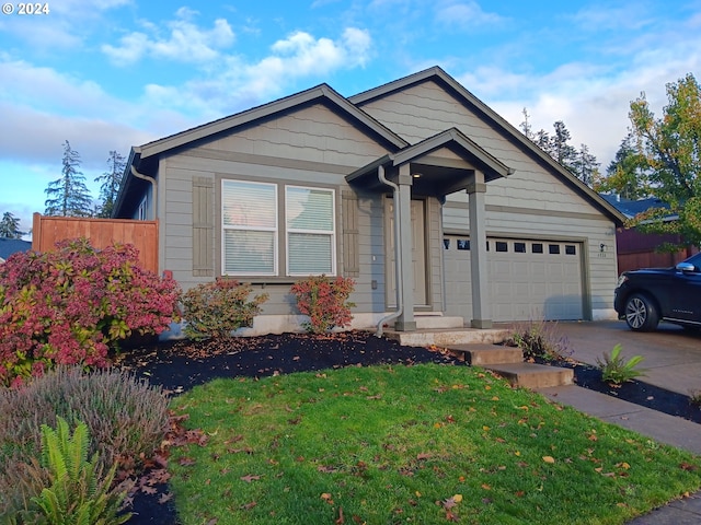 view of front of home featuring a front yard and a garage