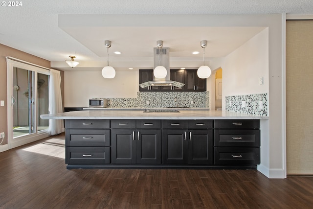 kitchen featuring island exhaust hood, decorative light fixtures, backsplash, and dark hardwood / wood-style floors