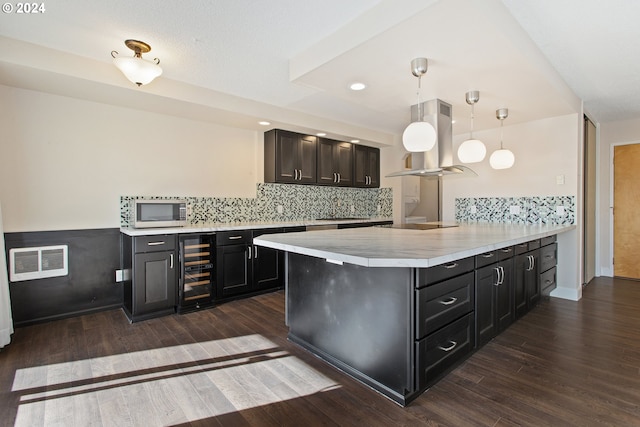 kitchen with wine cooler, kitchen peninsula, pendant lighting, and dark hardwood / wood-style flooring