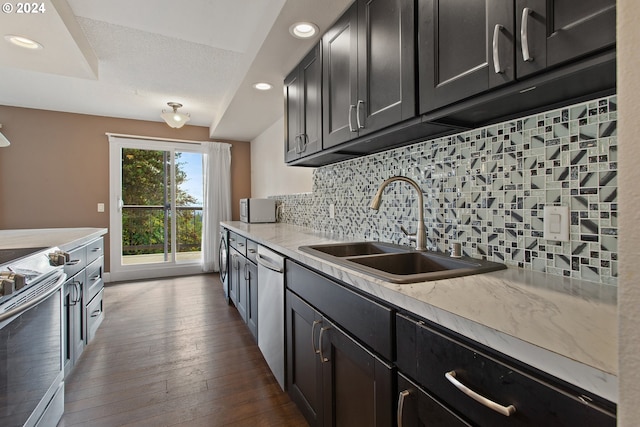 kitchen featuring decorative backsplash, dark wood-type flooring, stainless steel appliances, sink, and light stone counters