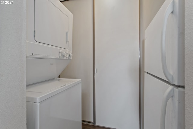 laundry area featuring wood-type flooring and stacked washer and dryer