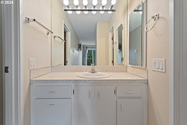 bathroom featuring vanity and a textured ceiling