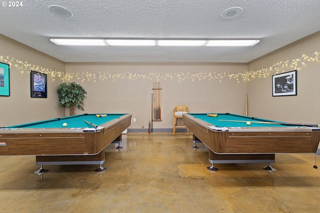 game room featuring pool table, a textured ceiling, and concrete flooring