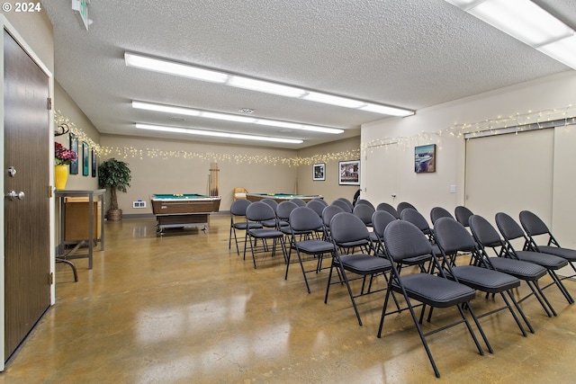 miscellaneous room featuring concrete floors, a textured ceiling, and billiards