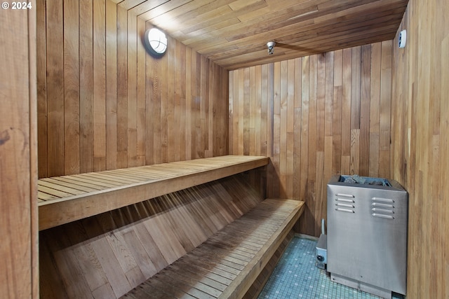 view of sauna with wood ceiling, wooden walls, and tile patterned floors