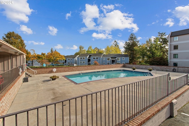 view of swimming pool with a patio