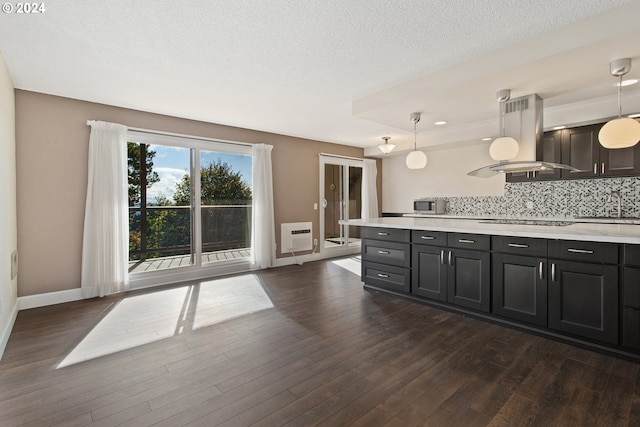 kitchen featuring island range hood, decorative light fixtures, and dark hardwood / wood-style floors