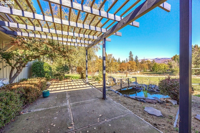 view of patio / terrace featuring a mountain view and a pergola