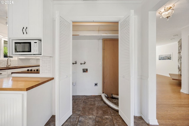 interior space featuring hardwood / wood-style floors, decorative backsplash, and sink