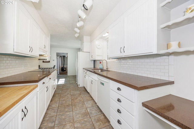 kitchen featuring backsplash, white appliances, white cabinetry, and sink