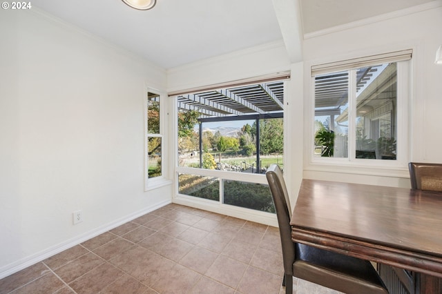 unfurnished dining area featuring beamed ceiling, light tile patterned floors, and ornamental molding