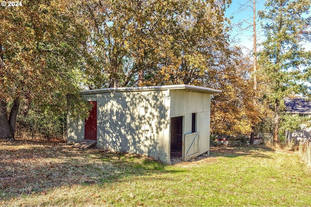 view of outdoor structure featuring a lawn