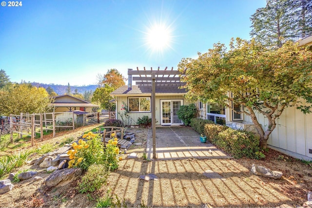 rear view of property featuring a patio area and a pergola