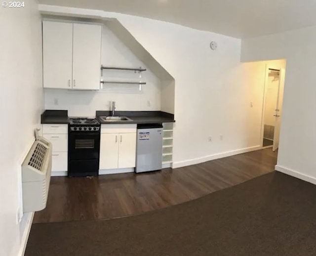 kitchen featuring dishwasher, black range oven, sink, dark hardwood / wood-style floors, and white cabinets