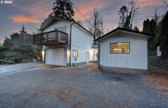 view of front of house with a garage and a balcony