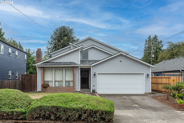 view of front of property featuring an attached garage, driveway, fence, and brick siding