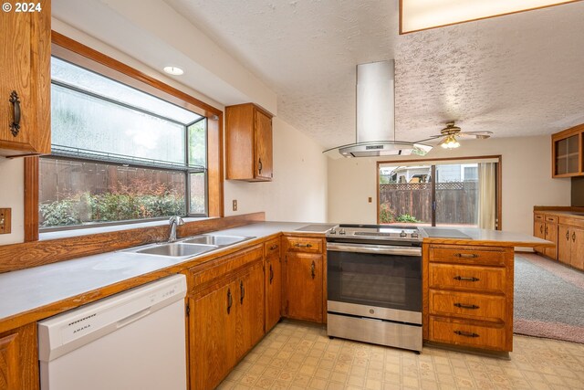 kitchen featuring stainless steel range with electric stovetop, island exhaust hood, white dishwasher, and a wealth of natural light