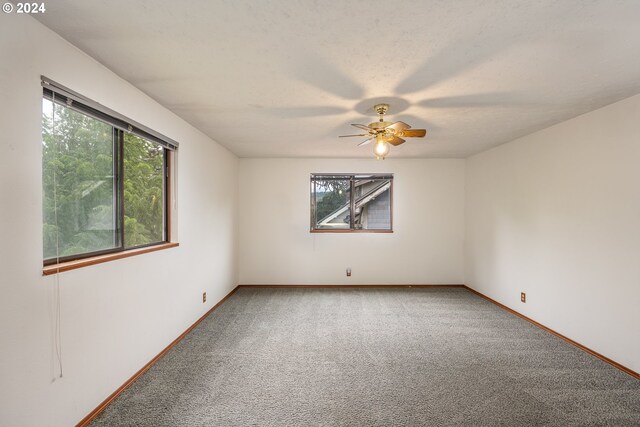 unfurnished room featuring carpet flooring and ceiling fan