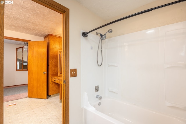 bathroom featuring tub / shower combination, a textured ceiling, and tile patterned flooring