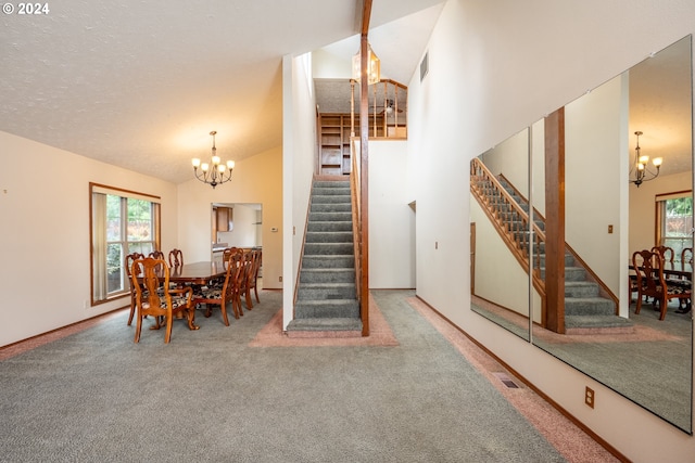 interior space featuring a wealth of natural light, carpet, and an inviting chandelier