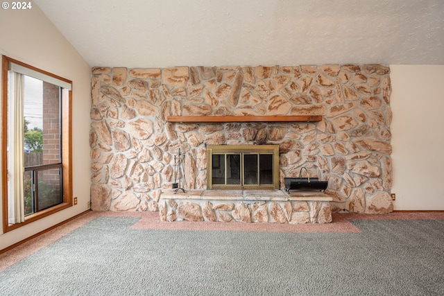 unfurnished living room with a fireplace, carpet flooring, vaulted ceiling, and a textured ceiling