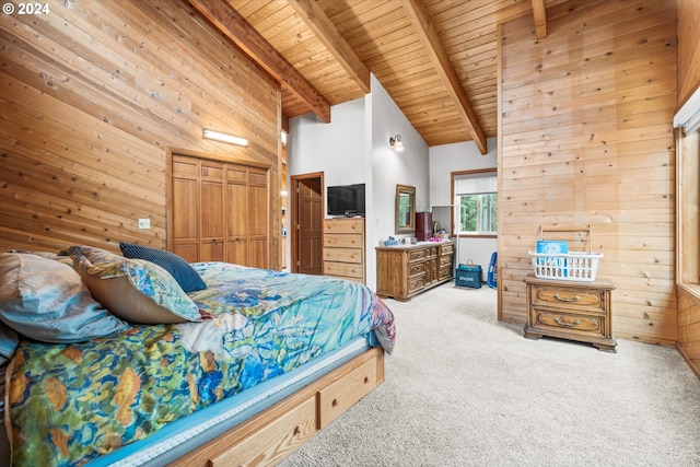 bedroom with wooden ceiling, light colored carpet, and wooden walls