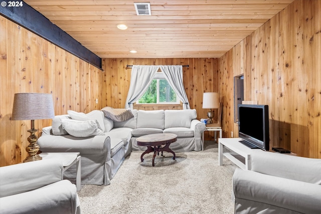 living room featuring wood walls, carpet floors, and wooden ceiling