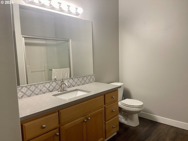 bathroom featuring hardwood / wood-style floors, vanity, and toilet