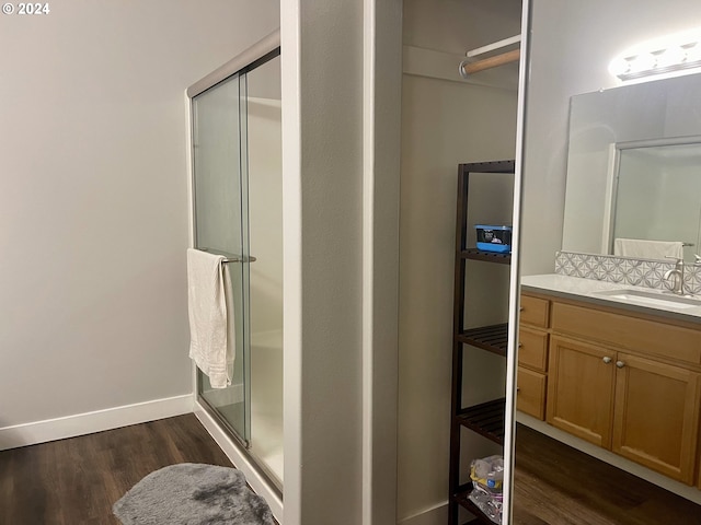 bathroom featuring vanity, an enclosed shower, and hardwood / wood-style flooring