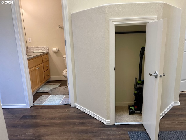 bathroom featuring vanity, hardwood / wood-style flooring, and toilet