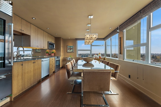 1220 NE 17th Ave Unit 17H, Portland, OR 97232 - dining area featuring dark wood-type flooring and baseboards