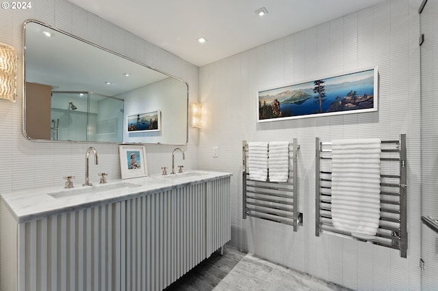 1220 NE 17th Ave Unit 17H, Portland, OR 97232 - bathroom featuring a stall shower, double vanity, and tile walls