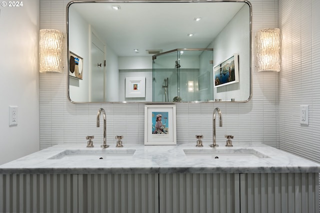 1220 NE 17th Ave Unit 17H, Portland, OR 97232 - bathroom with tasteful backsplash, double vanity, a shower stall, and tile walls