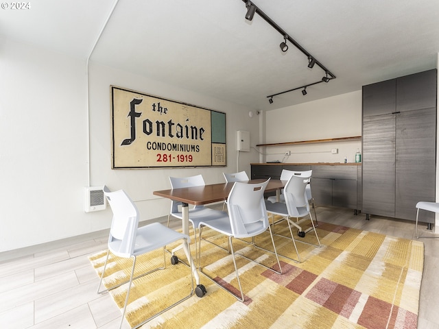 dining space featuring light wood-type flooring and rail lighting