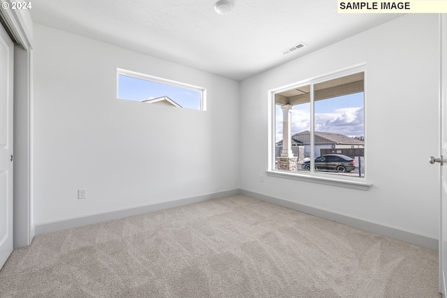 spare room with light colored carpet