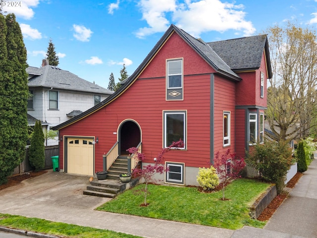 view of front of house with a front lawn and a garage