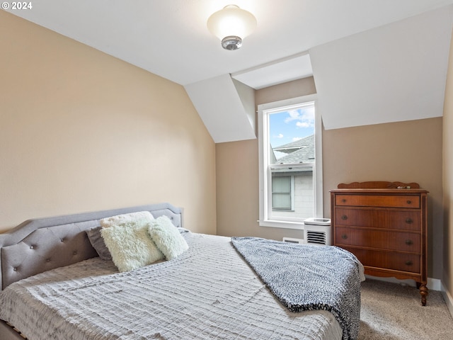 carpeted bedroom with lofted ceiling