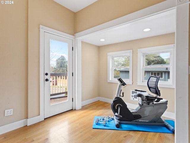 exercise room with recessed lighting, baseboards, and wood finished floors