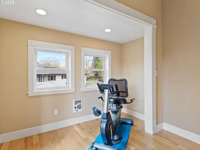 exercise room featuring recessed lighting, baseboards, and wood finished floors