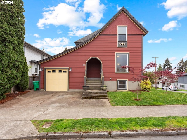 view of front of house with a front yard, fence, an attached garage, entry steps, and concrete driveway