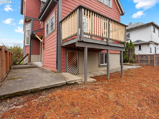 back of property with a patio area, a fenced backyard, and a wooden deck